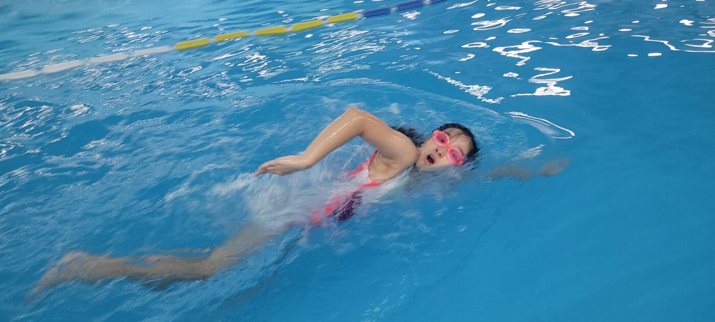 Student swimming laps for the fundraising swim