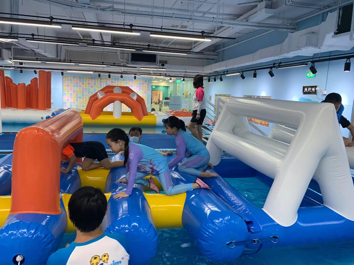 Children crawling through the inflatable ninja obstacles
